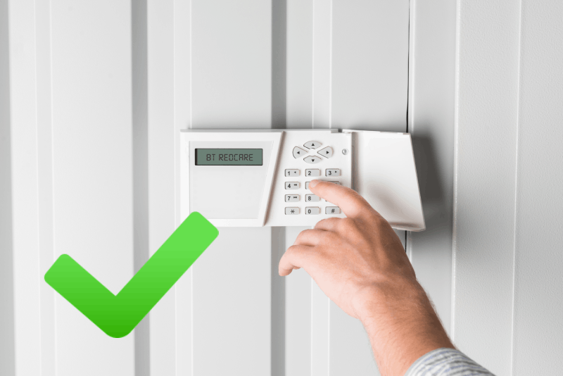 A person operating a security alarm keypad with the display showing 'BT Redcare,' accompanied by a green checkmark, representing reliable and secure alarm monitoring solutions.